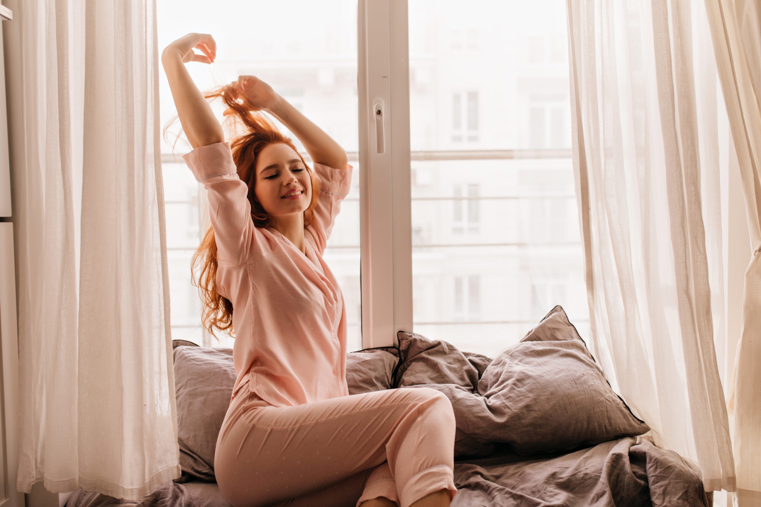 Woman stretching in cozy morning light