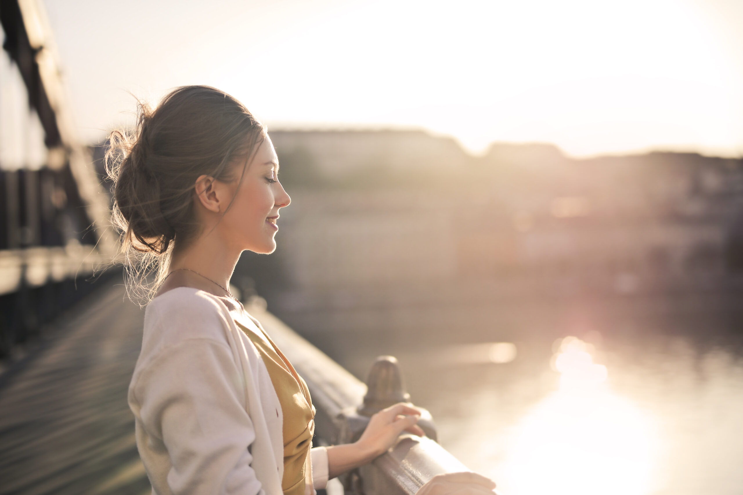 Woman reflecting peacefully by the water